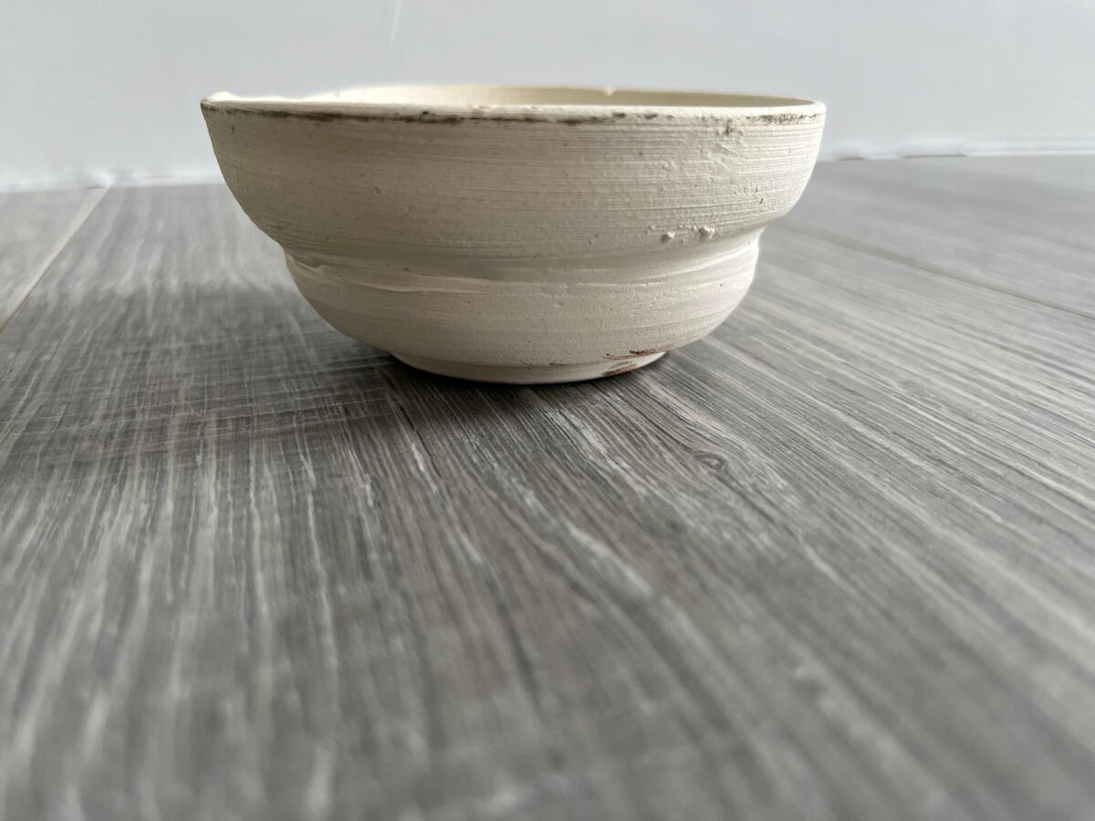Handmade clay bowl with textured concentric ridges